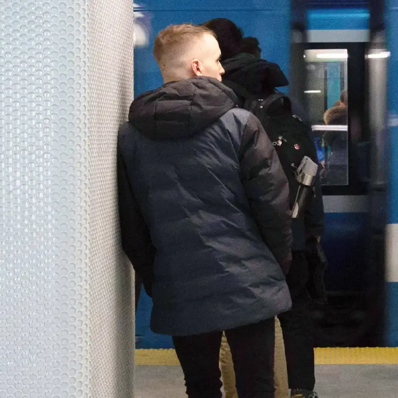 Our model wears the OFFICE anthracite-black winter jacket, seen from behind at the metro station.