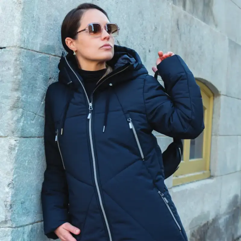 Our model wears the winter jacket long COSMO black, front view, 44752