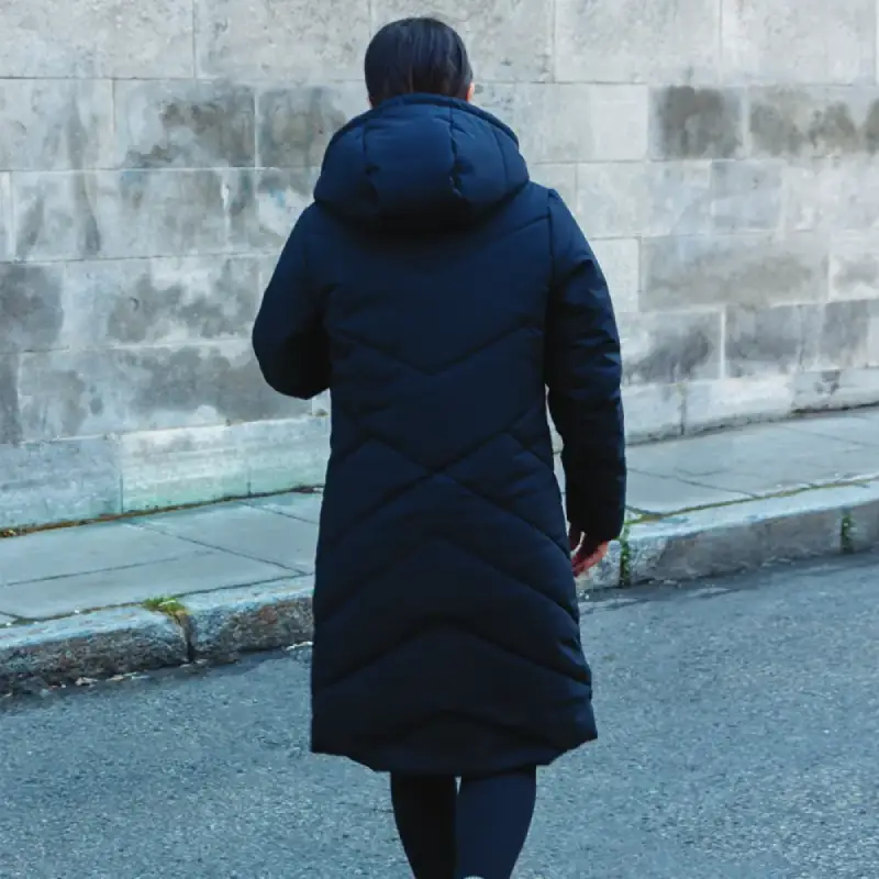 Our model wears the winter jacket long COSMO black, back view, 44752