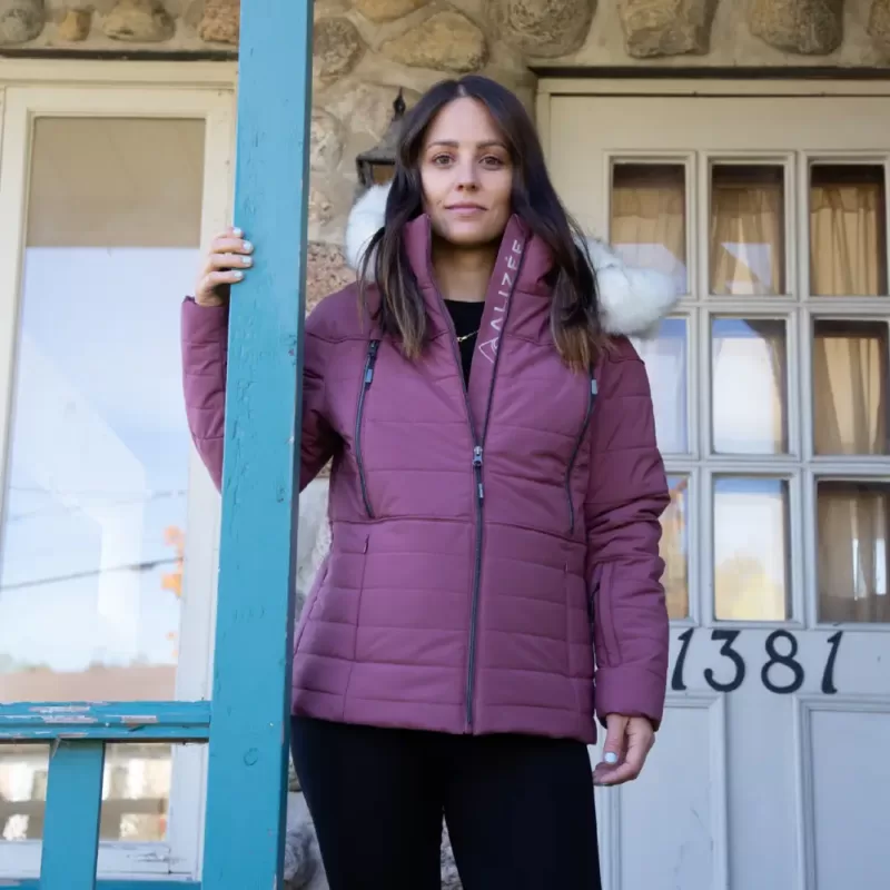 Our model wears the NEW LADY berry-colored insulated winter jacket for women out on the town.